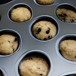a muffin tin that is 2/3 full with the muffin mixture.