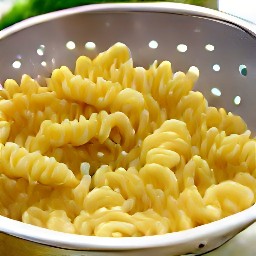 the pasta is drained in a colander.
