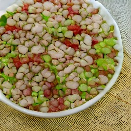 a chilled mixture of pinto beans, white corn, cowpeas, red bell peppers, green bell peppers, onions and vinaigrette.
