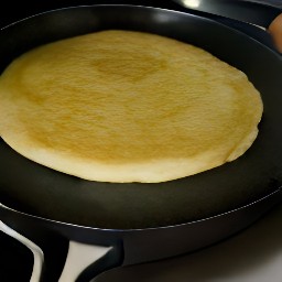 a semi-cooked pancake that has been flipped and cooked for 1 more minute.