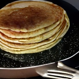 the food is transferred from the pan to a plate.