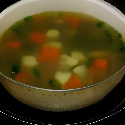 the veggie soup is divided into bowls.