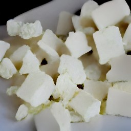 a salad with cucumber, parsley, black olives, feta cheese, tomatoes, and onion.