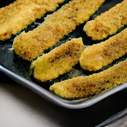 the zucchini fingers are now flipped over and will continue to cook on the other side.