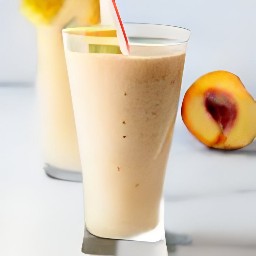 the peach and banana smoothie is divided into serving glasses.