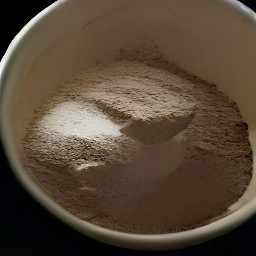 a bowl of flour with cocoa powder, baking soda, and baking powder stirred in.