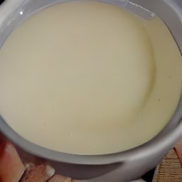 a bowl of soy milk, cider vinegar, granulated sugar, canola oil, and vanilla extract mixed together.