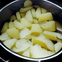 a crock pot full of potatoes, onions, oregano, salt, black pepper, and butter that has been cooked for 4 hours at a high temperature.
