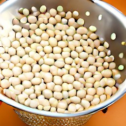 the soaked cowpeas are drained in a colander.