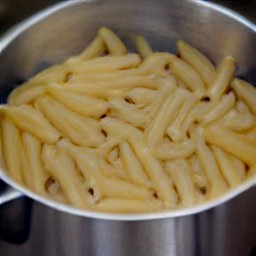 a pot of cooked whole wheat penne pasta.