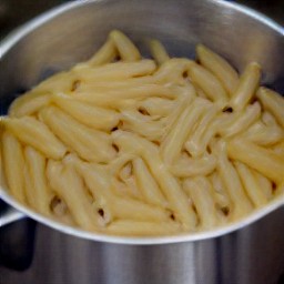 a pot of cooked whole wheat penne pasta.