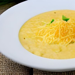the corn and grits are transferred to a serving plate.