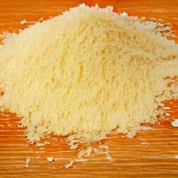 the parmesan cheese is grated into small pieces.