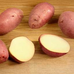 the red potatoes are cut in half lengthwise.