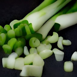 garlic that has been peeled and then chopped scallions.
