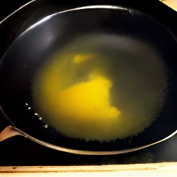 the sunflower oil heats up in the skillet.