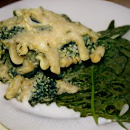 a platter of easy pasta bake with a side of arugula.