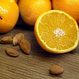 peeled and sliced oranges, and cut almonds in half.