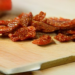 garlic that is peeled and chopped, then sun-dried tomatoes that are diced.