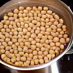 the chickpeas are rinsed in a colander.