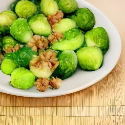 the cooked brussels sprouts are removed from the skillet and placed on a serving bowl.