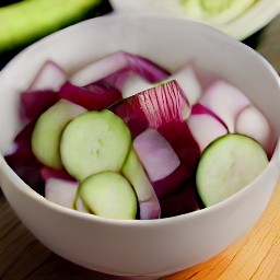 a bowl of mixed beets, cucumbers, and red onions.