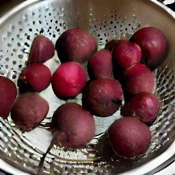 the cooked beets are rinsed with cold water and then drained.