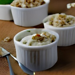 a mixture of walnuts, apricots, and cheesy butter that has been divided into ramekins and covered with cling film. the mixture will chill in the fridge for 120 minutes.