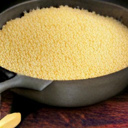 a pan of couscous with fruits juice and rose water.