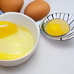 the egg whites fall into the bowl while the yolks remain in the spoon.