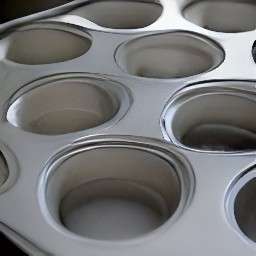 the muffin tin is coated in a thin layer of cooking spray.