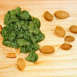 the spinach is cut into thin slices, and the almonds are also cut into thin slices.