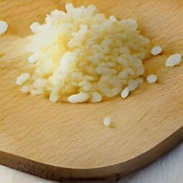 a bowl of peeled and minced garlic.