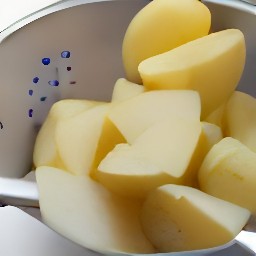 the boiled potatoes are drained in a colander.