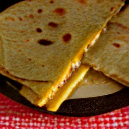 the cheese chapati sandwich is now flipped over.