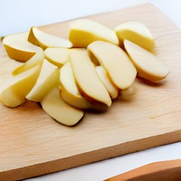 potatoes cut into wedges and parsley that has been chopped.