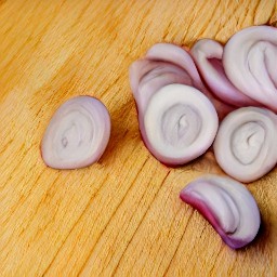 a peeled and thinly sliced shallot.