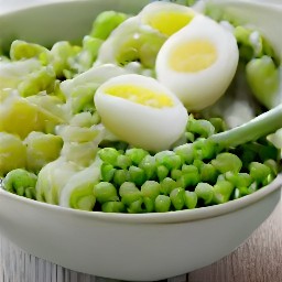 the salad with basil and peas is transferred to a plate. the eggs are halved and placed on top of the salad. the salad is then seasoned with black pepper.