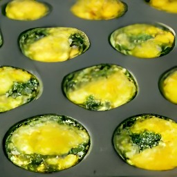 the spinach mixture is divided into foil baking cups.