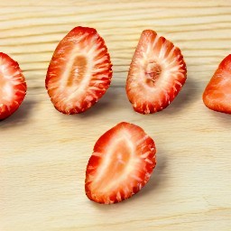 a bowl of sliced strawberries.