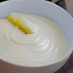a bowl of muffin mixture with pineapple slices mixed in.