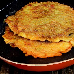 flipping semi-cooked pancakes with a spatula.