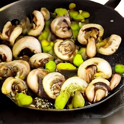 a pan of stir-fried portabello mushrooms with onions, ginger, garlic, and green chili peppers.