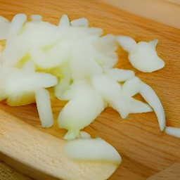 peeled onions and garlic that are chopped.