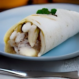 a flour tortilla with a cream cheese mixture, mashed bananas, and ground cinnamon sprinkled on top.