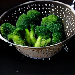 steamed broccoli that has been drained in a colander.