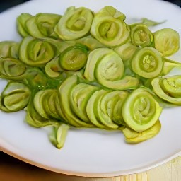 the fried leeks are transferred to a platter.