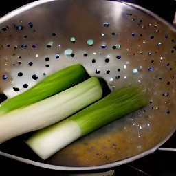 the leek halves are drained in a colander.