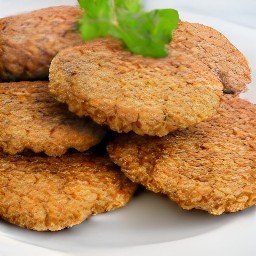 12 chickpea dough balls that have been pressed flat to form patties.