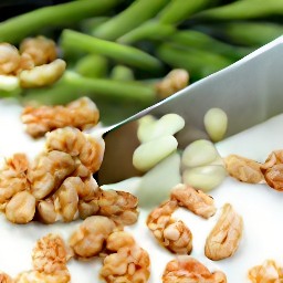 after chopping the walnuts, peel and slice the garlic cloves. trim and cut the green beans into small pods.